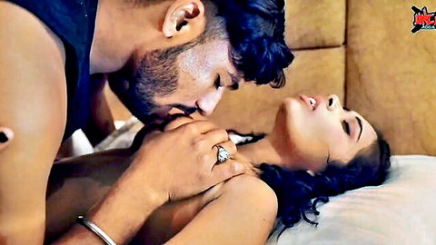 Young Indian couple in passionate neck kiss, man caressing topless woman's breast