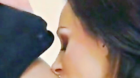 Two lesbians in sensual close-up kiss on neck and shoulder