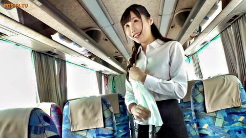 Smiling Japanese bus guide in white blouse and black skirt uniform