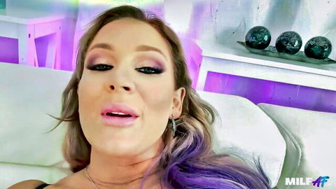 Blonde MILF with purple hair puckers glossy lips seductively for blowjob tease