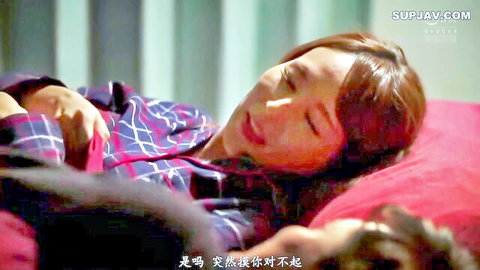 Petite East Asian woman sleeping in plaid pajamas on red pillow bed