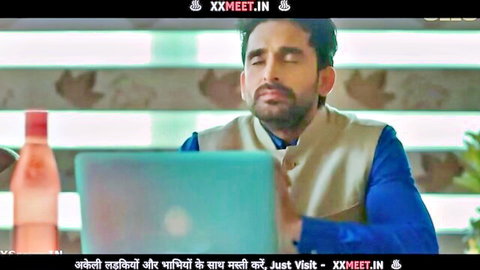 Handsome Indian man in kurta sitting at desk with laptop promoting girlfriend fuck fun on XXMEET.IN