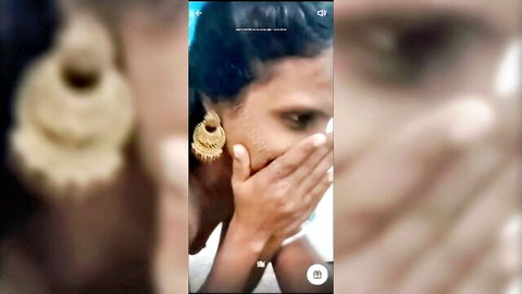 Shocked South Asian man covering mouth with hand beside woman's gold earrings in Snapchat close-up