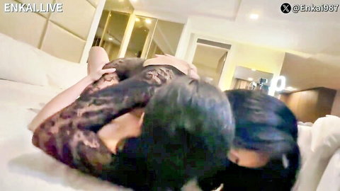 Two Filipina women in lace lingerie sharing intimate embrace