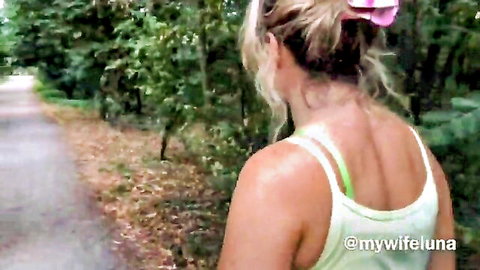 Blonde Luna walking outdoors in tight green tank top, teasing athletic back view