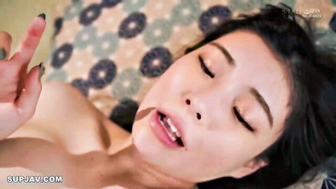 Close-up of beautiful Asian wife moaning with eyes closed, long dark hair