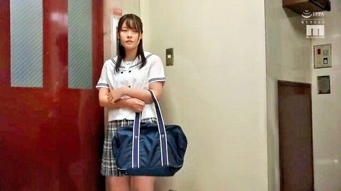 Stern Japanese schoolgirl in sailor uniform arms crossed holding bag in elevator