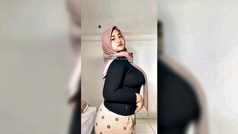 Indonesian hijab teen with huge tits in tight black top and polka dot pants posing seductively
