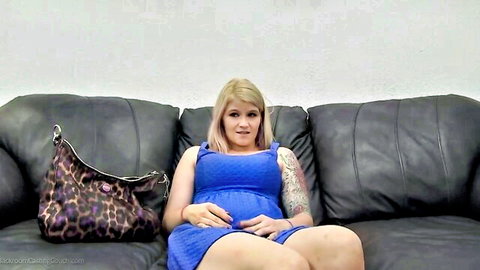 Pregnant blonde Tatumn in tight blue dress, teasing on couch