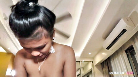 Young Thai maid Patricia topless, black hair bun, seductive gaze