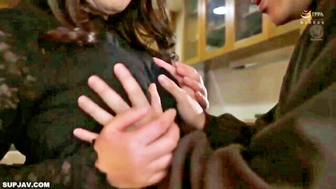 Japanese man roughly gropes busty brunette's tits from behind in kitchen