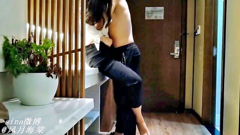 Asian woman with long hair bent over counter getting fucked doggy style by shirtless man