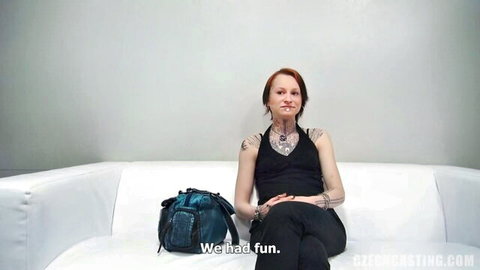 Tattooed redhead in black tank top at casting couch interview