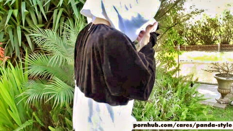 Nicole Aniston in panda costume outdoors, teasing from behind