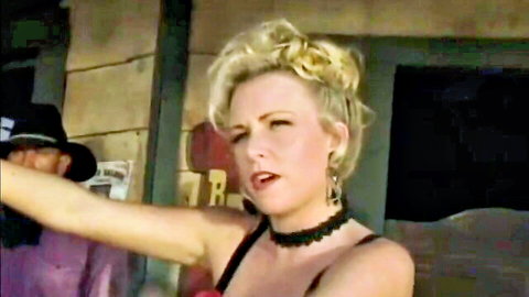 Kylie Ireland in Western Nights, blonde in saloon showdown pose