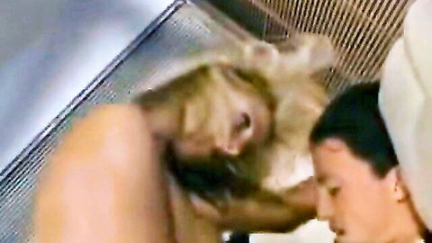 Blonde mature with big tits passionately kisses topless brunette woman close-up