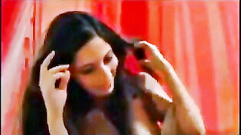 Kurdish woman with long black hair and cleavage posing seductively