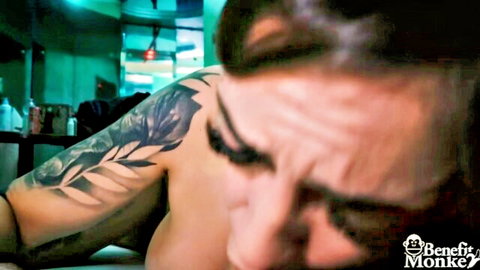 Marika Milani close-up, bare arm with rose tattoo, seductive gaze