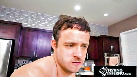 Muscular hairy shirtless guy in kitchen staring intensely for gay fisting video