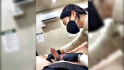 Gloved masked Asian doctor strokes big erect cock in medical clinic handjob
