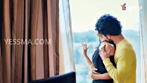 Romantic Indian couple embracing intimately by window, Diya