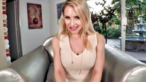 Blonde amateur in low-cut top smiling seductively