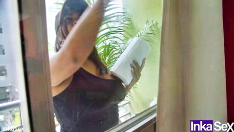 18-year-old Venezuelan woman in tank top surprised on balcony