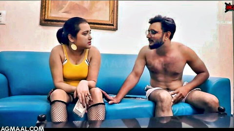 Indian MILF in yellow top fishnets holds cash teasing shirtless hunk on sofa