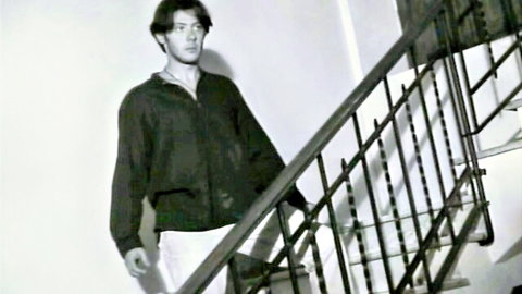Young man in black jacket and white pants on stairs, 1998 Italy vibe with Alissa Arden
