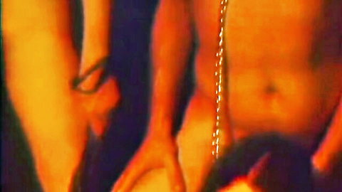 Vintage 1974 porn thumbnail: muscular nude man with chain necklace, female hands caressing torso