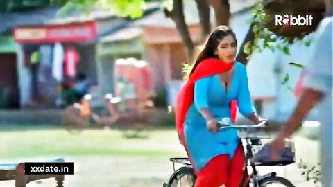 Slim Indian beauty Yorgelis Carrillo in blue salwar kameez riding bicycle outdoors