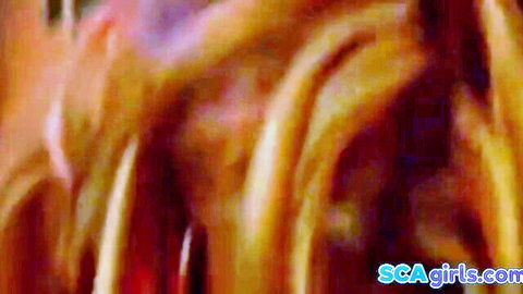 Blurry closeup of wild blonde hair flying in intense threesome action