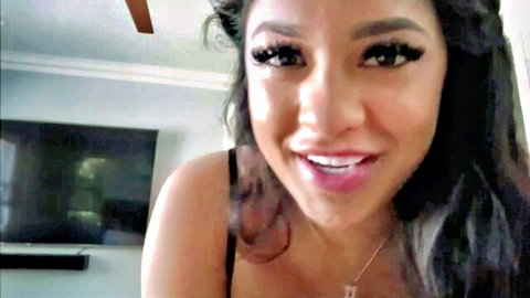 Smiling brunette MILF with plump glossy lips and heavy makeup teasing closeup