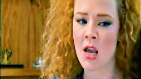 Redhead with big curly hair opens mouth wide moaning in pleasure closeup