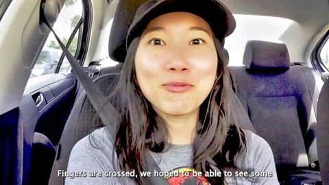 Luna Okko smiling in car on Hawaii trip, fingers crossed for fun
