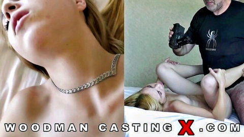 Petite blonde teen lies naked on bed spreading legs exposing shaved pussy for camera in Woodman casting