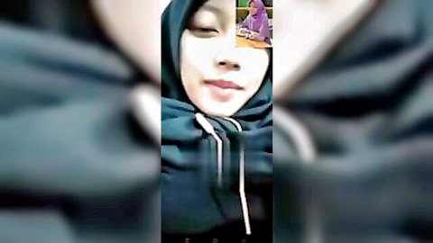 Sexy Asian hijabi girl smiling seductively in closeup homemade selfie