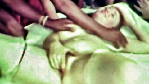 Vintage blonde babe's huge tits groped by multiple black hands on bed