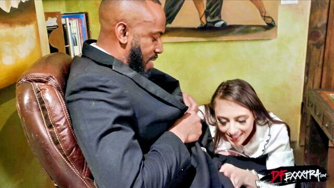 Brunette woman in white blouse teases suited black man's bulge