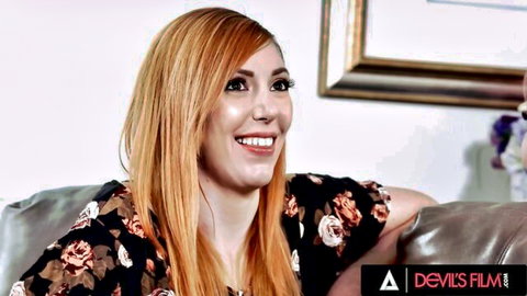 Lauren Phillips redhead smiling in floral top - Devils Film swinger foursome