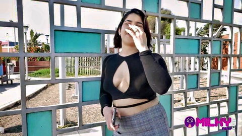 Busty Latina teen teasing huge tits in deep cleavage black top outdoors in public park