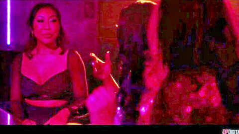 Asian woman in revealing black lingerie gesturing at bachelorette party shenanigans
