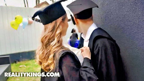 Little Angel in black graduation cap and gown embraces boyfriend at party