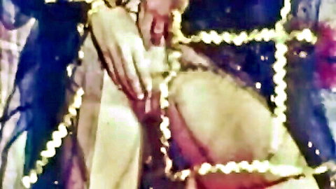 Seductive harem girl in blue and gold attire posing provocatively