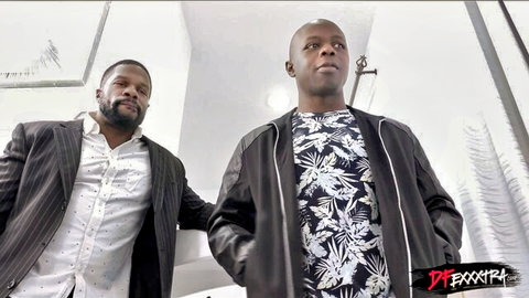 Two handsome black men in suits and leather jacket posing confidently together