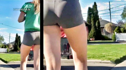 Petite teen's small tight ass in gray shorts teasing from behind outdoor candid