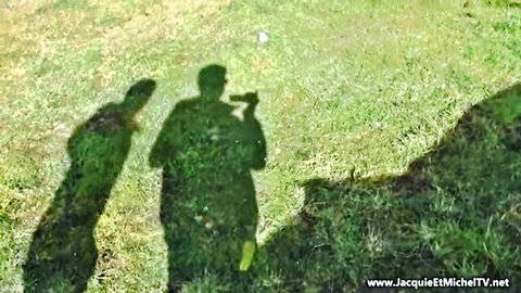 Outdoor shadows of French gay porn shoot with camera on lush green grass Jacques et Michel