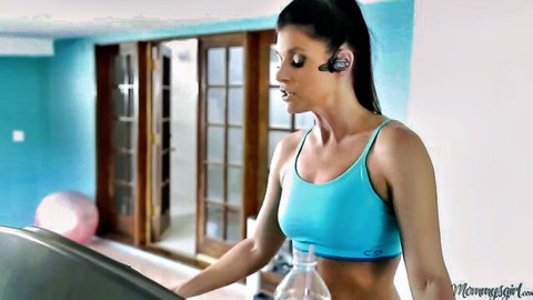 Busty MILF in tight blue sports bra jogging on treadmill with ponytail and headset