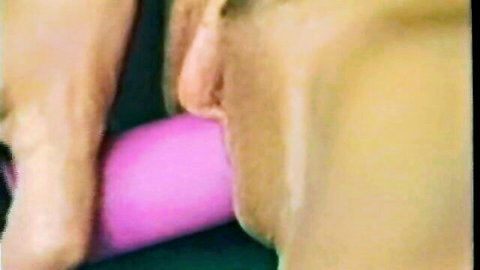 Vintage blonde woman giving blowjob to pink dildo close-up, 1991 uncut porn