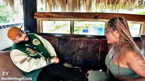 Tattooed big tits Latina MILF in tight green top cuddles with stud on tropical couch